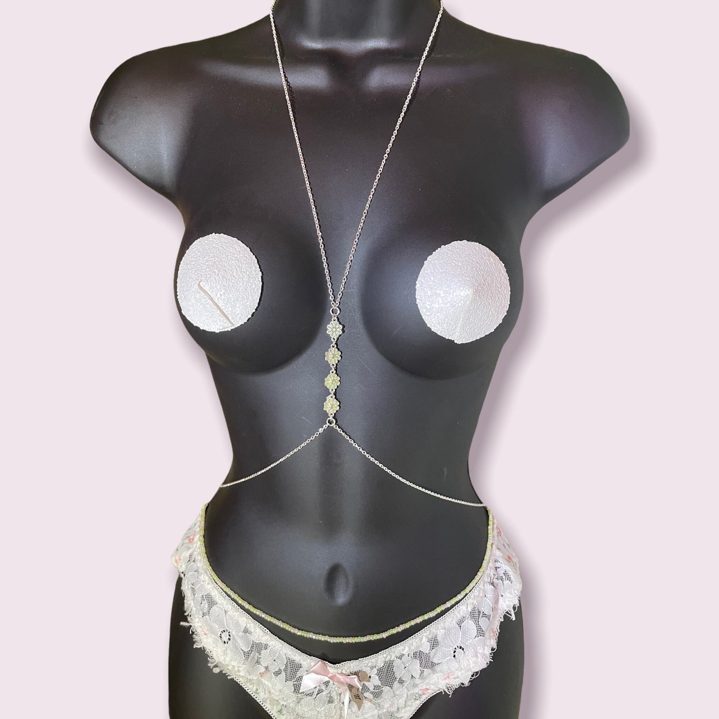 Glow in the dark floral body chain set in the light.