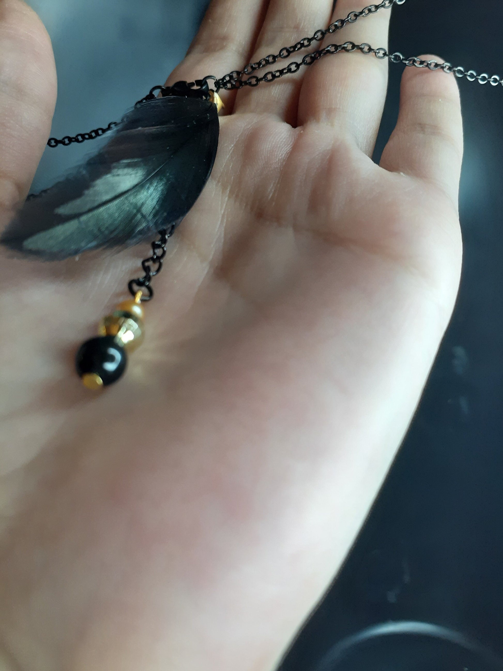 Feathered beaded accents at the end of the chain